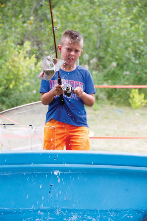 Ellis Ruhkala, 10, catches a fish during the kids fishing derby held in Bockman Park.