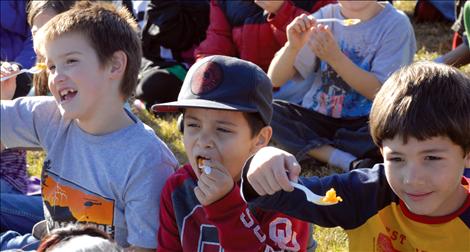 Three Ronan second graders say “Salut,” before tasting their squash. 