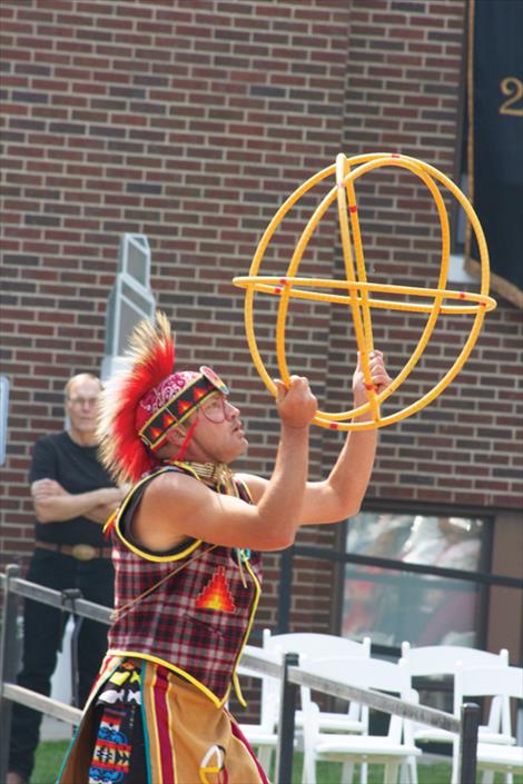 A member of the Flathead Reservation Traditional Dance Troupe performs a hoop dance.