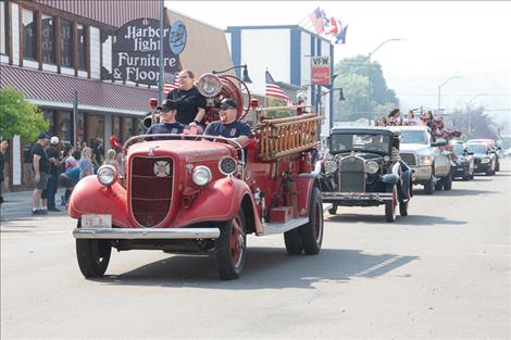 An old Polson fire truck makes its way down Main Street during the parade. 