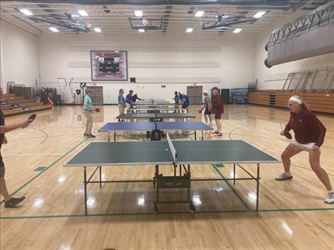 Participants compete in a table tennis tournament at the 2023 South Dakota Senior Olympics. 