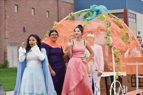  a group of RHS seniors wave from their Disney-themede float during last  Friday’s Homecoming parade.