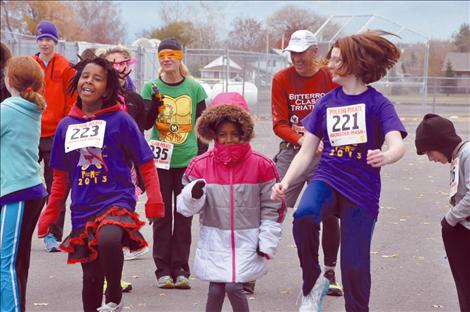 Runners dressed in costume take off in the 5K race at Linderman Elementary School’s Monster Mash. 