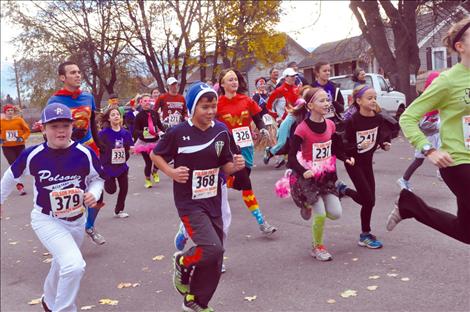 Runners dressed in costume take off in the 5K race at Linderman Elementary School’s Monster Mash. 