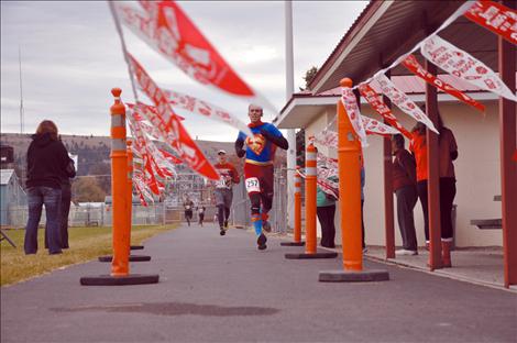  James Ives, dressed as Superman, crosses the finish line in third place at Linderman