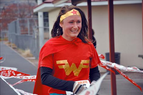 Jordan Ives, dressed as Wonder Woman, smiles as she takes first place in the Linderman Elementary School Monster Mash 5K run. 