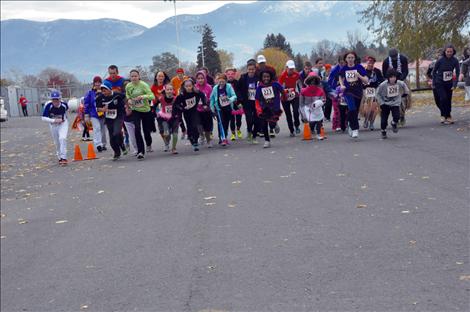 Runners dressed in costume take off in the 5K race at Linderman Elementary School’s Monster Mash. 