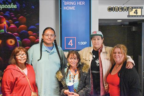 Movie goers at left and center pose for a photo with Patrick Yawakie, second from left, Krysti Reichman, far right, of the Flathead Reservation Human Rights Coalition and tribal legal advocate Erica Shelby, second from left.