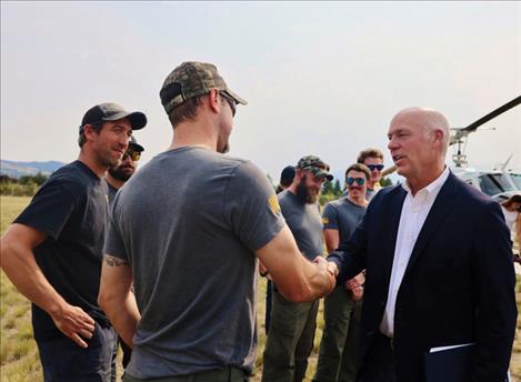 Governor Gianforte greets firefighters.