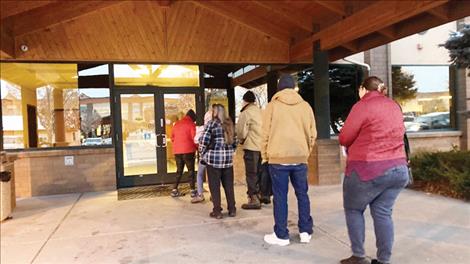 People line up outside a public assistance office in Missoula, Montana, before its doors open at 8 a.m., Oct. 27, 2023, to try to regain Medicaid coverage after being dropped from the government insurance program for people with low incomes and disabilities. Each said they had experienced long waits on the state’s phone helpline.