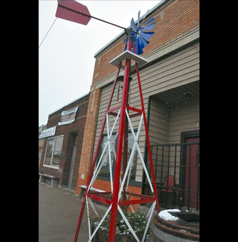 A windmill  outside the Second Chance Saloon was  broken and thrown into the middle  of the street last week. Now  re-erected, the damaged windmill is one of several cases of vandalism in Ronan over the past few weeks.