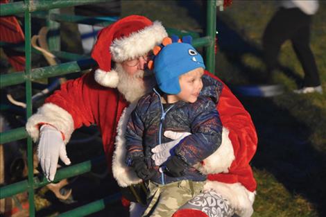 Five-year-old Andrew Richter sits on Santa’s lap at Good Old Days Park.