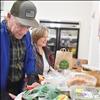 Polson Loaves and Fish volunteers Ted and Jeanne Breinhart prepare items for people to take from the food pantry.