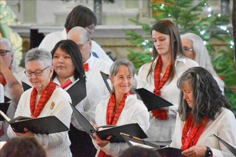 Janet Sucha, right, smiles over at another choir member.