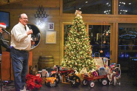 Beau Biggs photo Scott Biggs, owner of The Shoe, speaks to patrons who attended a fundraiser he hosted for Lake County’s Toys for Tots program.