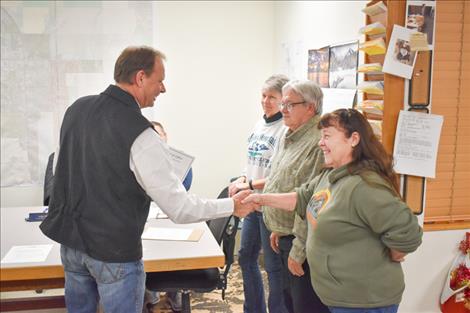 Ronan Mayor Chris Adler congratulates Ellen Kaphammer in her new position as Ronan City Council president.