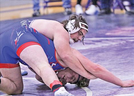 Pirate wrestler Jason Burrough works to pin his opponent during Jan. 4 duals in Polson.