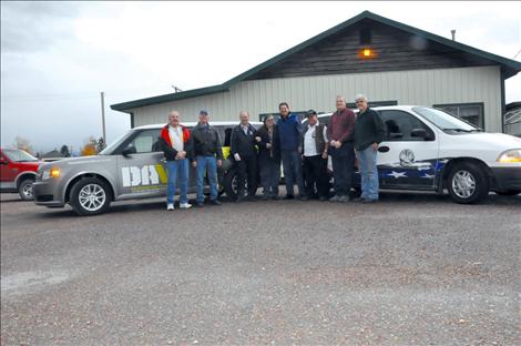 Members of the Ronan VFW and drivers for the Disabled American Veterans van stand with the new and older van, both in use to take Veterans to doctor appointments.