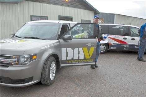 Jack Collins stands with a new 2013 Ford Flex Disabled American Veterans van that was bought with community donations. The  second van will mean fewer missed doctors appointments for Mission Valley veterans. 