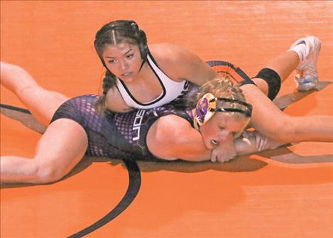 Ronan Maiden wrestler Leona Dodson Howe, 152, pins Polson’s Vanessa Wheeler.