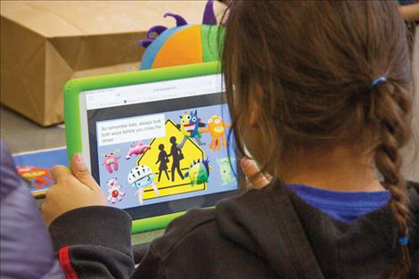 A Cherry Valley first grader watches a mini movie based on a  story written from a monster drawing he made last September.