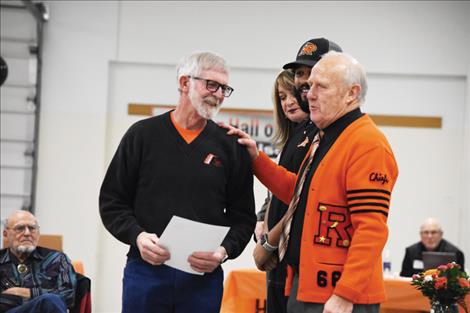 Lynn Olson, long time announcer for Ronan athletic events, is congratulated by Gail Decker as a new Hall of Fame inductee.