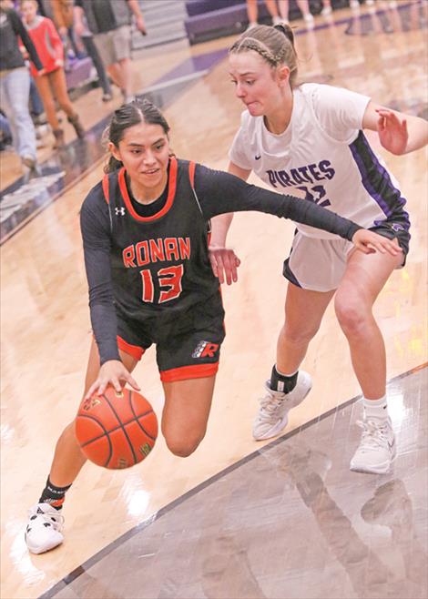 Ronan Maiden Arianna Zepeda drives by Lady Pirate Hinkley Moss during a Feb. 10 game.