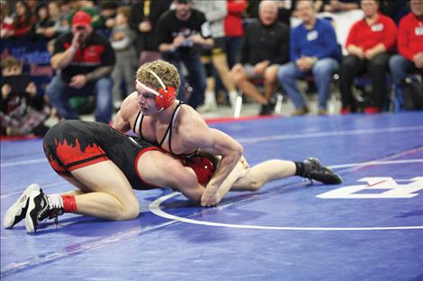 Landon Bishop of Ronan, top wrestler above, moved on to become the state champion at 170 pounds.