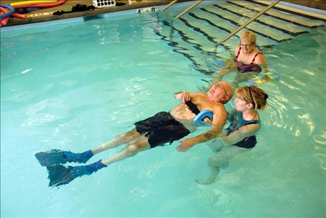 Chuck Lockwood and Sharon Murphy head for the edge of salt water therapy pool. Chuck works to increase his flexibility and gain strength for pure enjoyment.