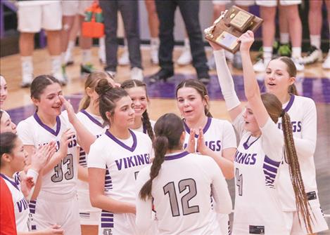 Charlo girls basketball players celebrate their District 14C championship win.