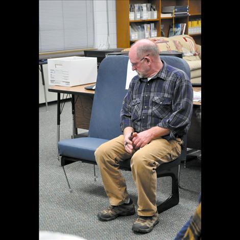 Rob Tougas, director of transportation for Ronan School District, used a bus seat as a visual aid during a presentation at the Nov. 11 board meeting. Three elementary-sized children can sit in a seat, but middle and high schoolers are squeezed with two bodies in a seat, Tougas explained. 