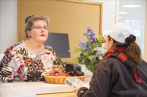 Public Services Librarian Angela Claver speaks with a library patron. 