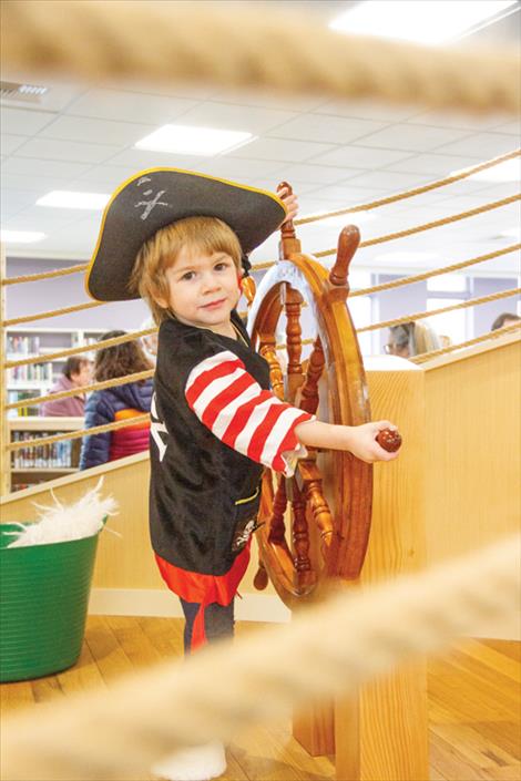 Teagan Couture, 3, takes the helm in the new pirate ship play feature in the children’s area of the library.