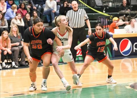 Neveah Perez and Arianna Zepeda move in for the rebound against Frenchtown during a divisional game.
