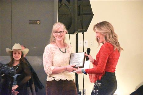 Bonnie Peterson, center, accepts Polson School District’s 2023 Certified Employee of the Year Award at the annual Polson Chamber of Commerce Community Awards banquet.