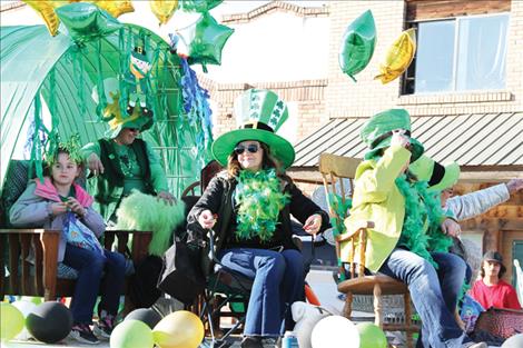 2024 parade participants sit on a float driven down Ronan’s Main Street.