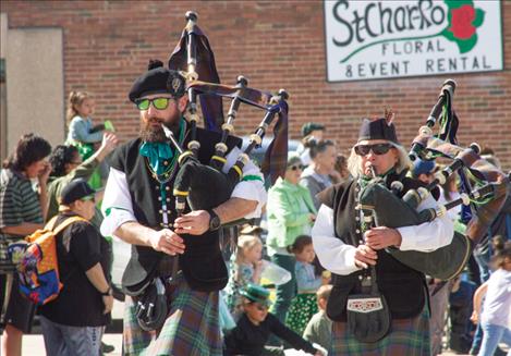 John Hamilton III and Sandy Ferrell of the Great Scots Pipes and Drum group play the bagpipes in the St. Patrick’s Day parade. The group took first in the “Most Irish” category.