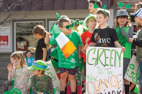 Kids wave from the Ronan Wrestling float.