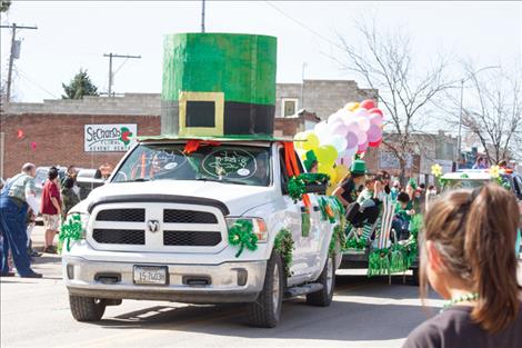 A large green hot tops a truck driven in Ronan’s St. Patrick’s Day parade