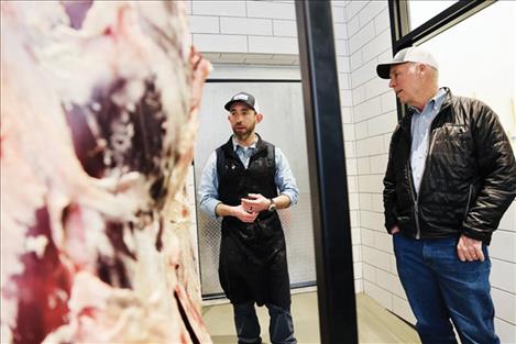 The Governor visits with a butcher at Central Avenue Meats in Great Falls during Ag week.