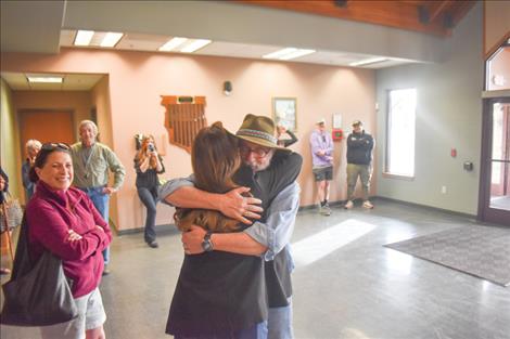 Frank Tyro embraces long-time coworker Julie Cajune who helped organize a surprise event honoring him for his many contributions to the Confederated Salish and Kootenai Tribes and Salish Kootenai College through his filmmaking career.