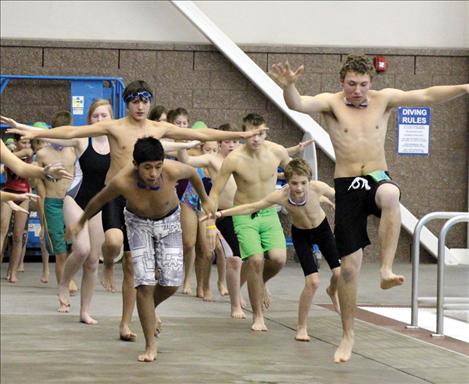 Members of the Lake Monsters swim team go through drills on the deck at Mission Valley Aquatic Center.