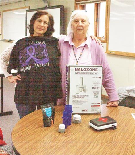 Francis Gates and Kathy Ross stand with a display of  items that will both help to educate the public and save lives of drug misusers.