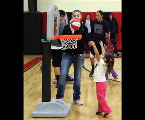 Tiny player Olivia Ramirez practices her layup during Itty Bitty Basketball.