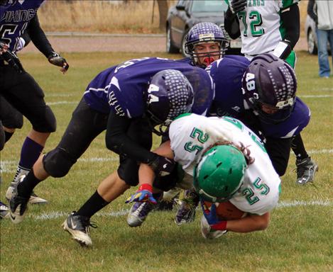 Below right, Vikings Jesse Long and Jade Smith knock an Ennis player to the turf.