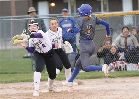 You make the call ... Kailey Smith of Polson reaches for the out as McElmury of Libby stretches for the base.