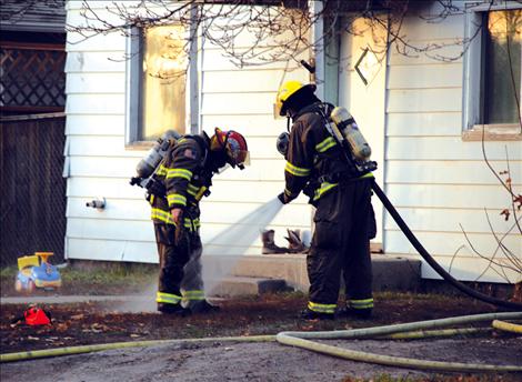 Polson firefighters hose off after saving a Polson home Monday, Nov. 11.
