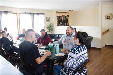 Steven Morigeau, Pablo residential director, visits with members of the NARSS community in the dining area of the new hub.