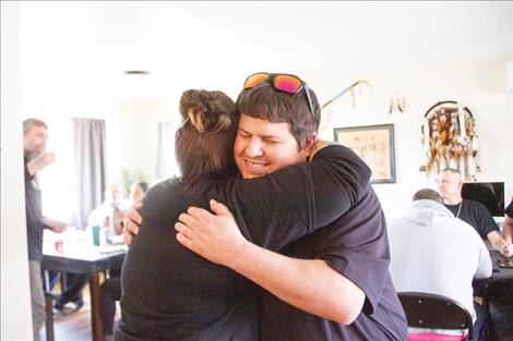 Zac Cannada gets a hug from Dessilynn Brown upon arrival to the recovery hub open house.