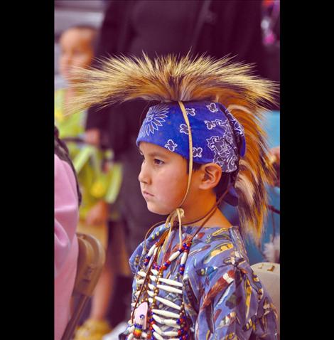 Uriah Michael watches dancers in the Headstart Powwow. 